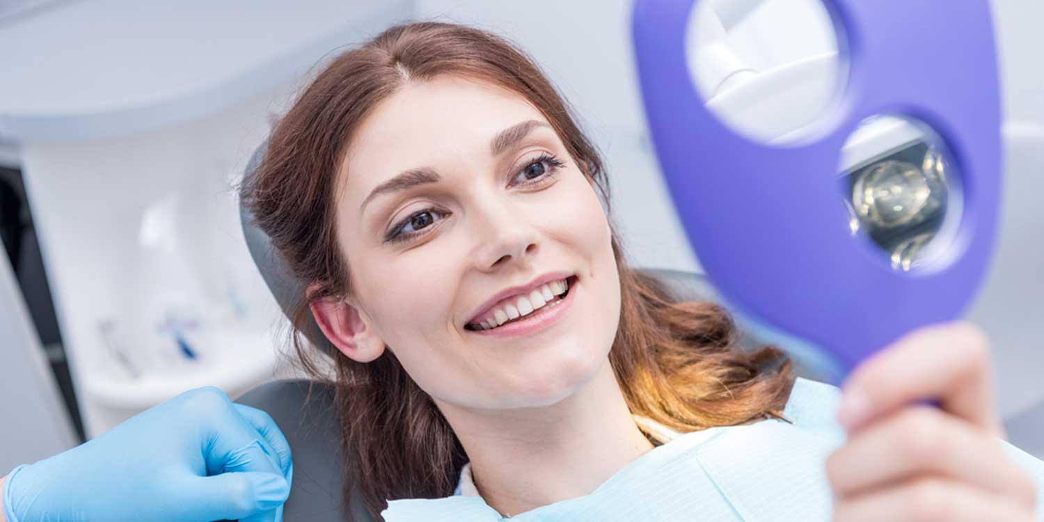 Happy patient is Looking at Her Face by Mirror